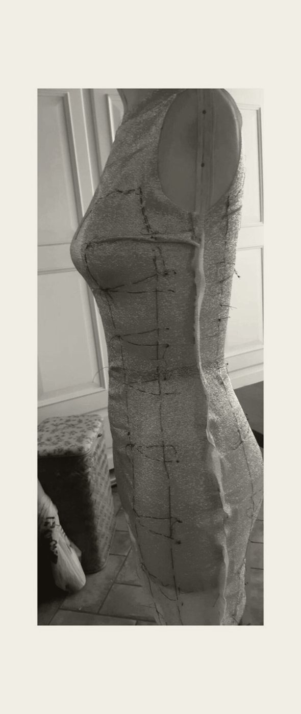 A fitted paper sheath toile on the form, side view