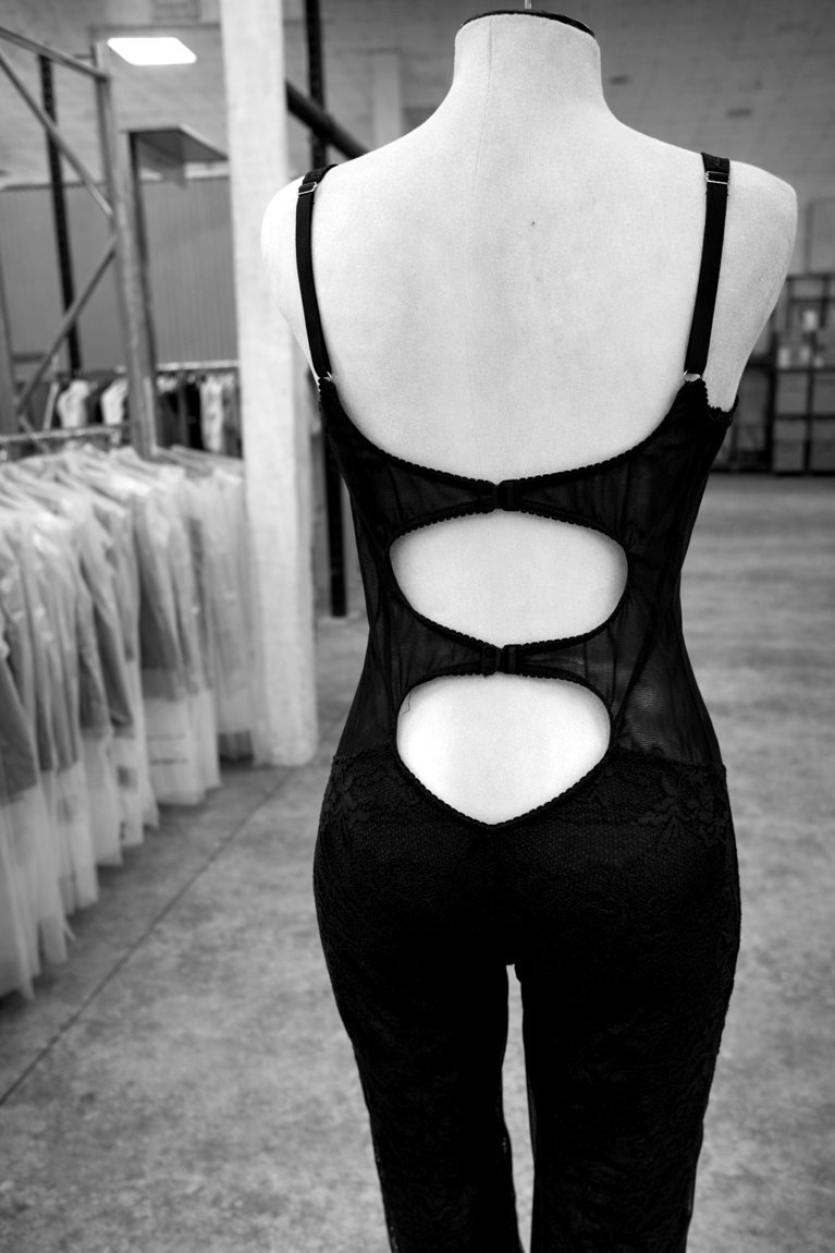 A lace and silk catsuit with keyhole cut-outs down the back, on the form
