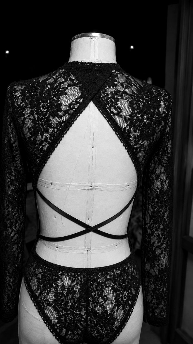 A lace bodysuit with a strappy open back