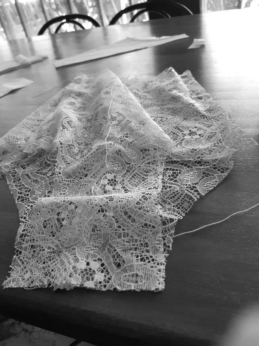 A lace panty just cut, held with a basting stitch before couture finishes are applied