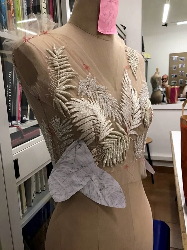 A silver fern appliqu&eacute; bodice on sheer tulle, on the mannequin