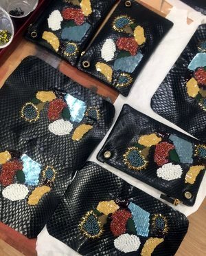 Multi-colour bead and sequin motifs worked onto black leather panels