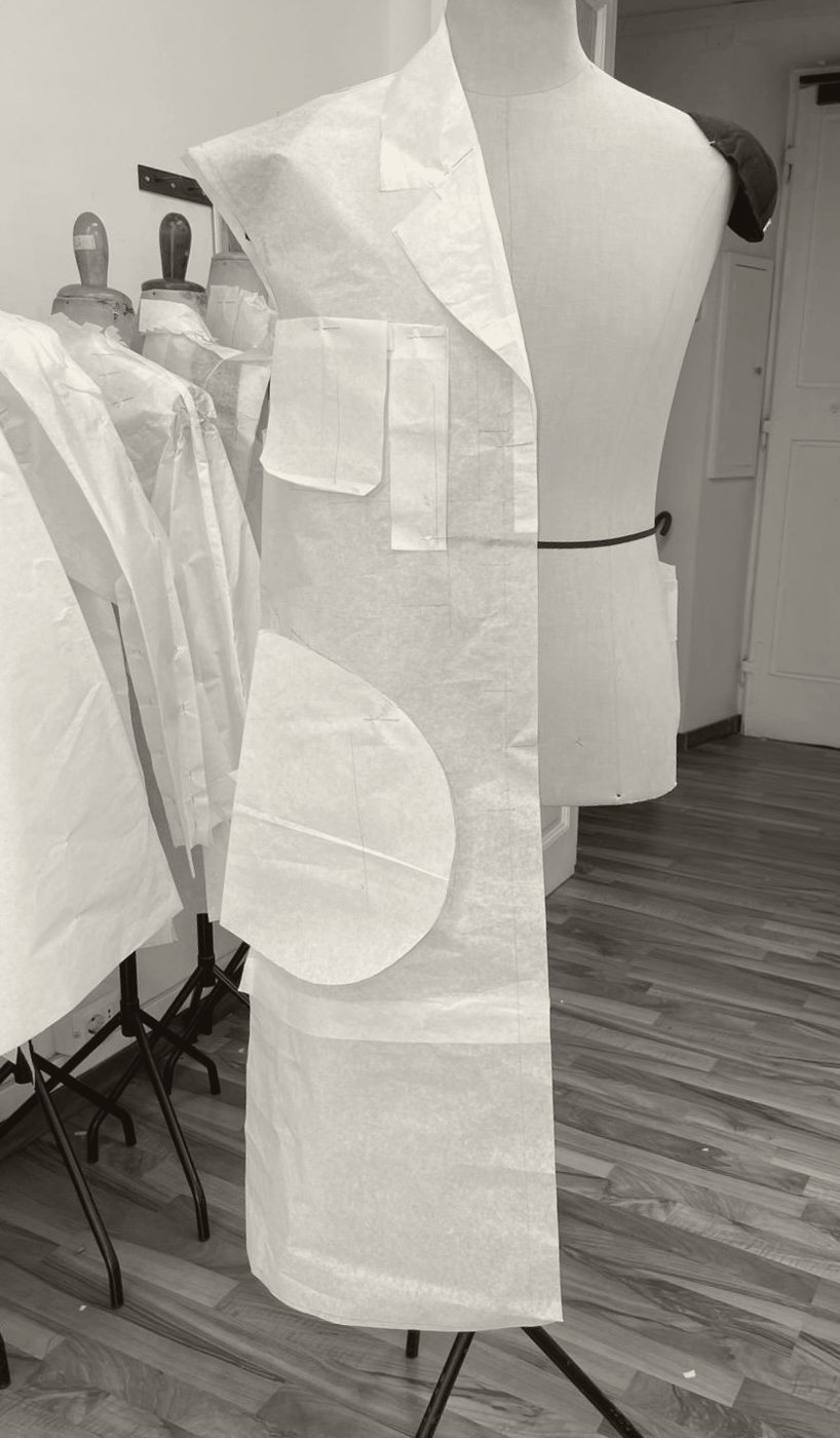 Paper toile, half-draped on the stand