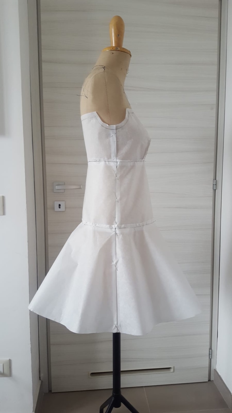 Paper bodice and flared skirt draped on the form, side view