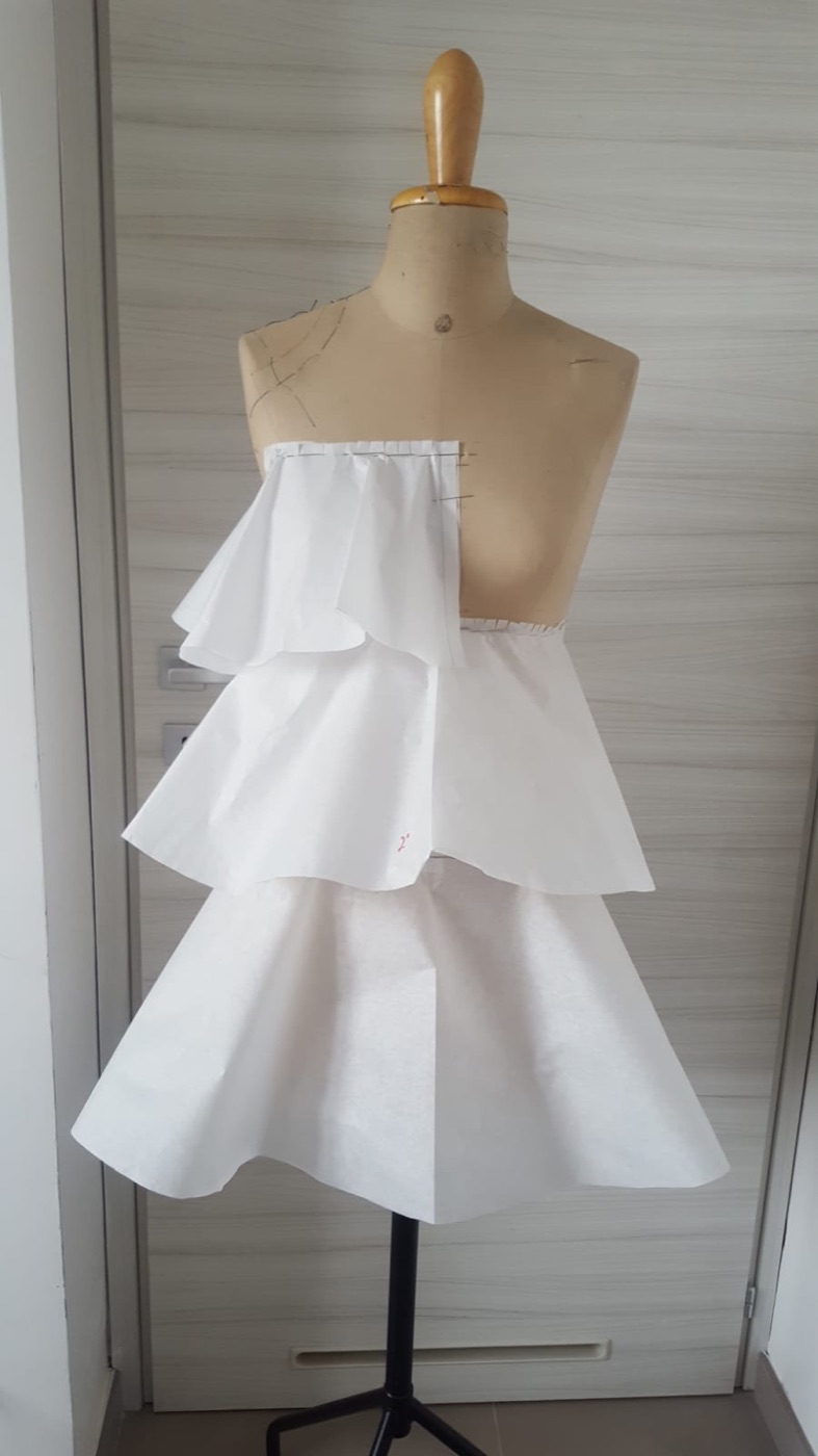 Three paper tiers draped on the mannequin, front view