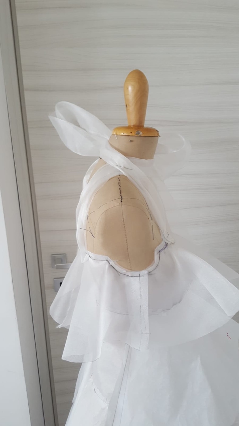 Pattern paper at the shoulder and neckline, marked by hand on the form
