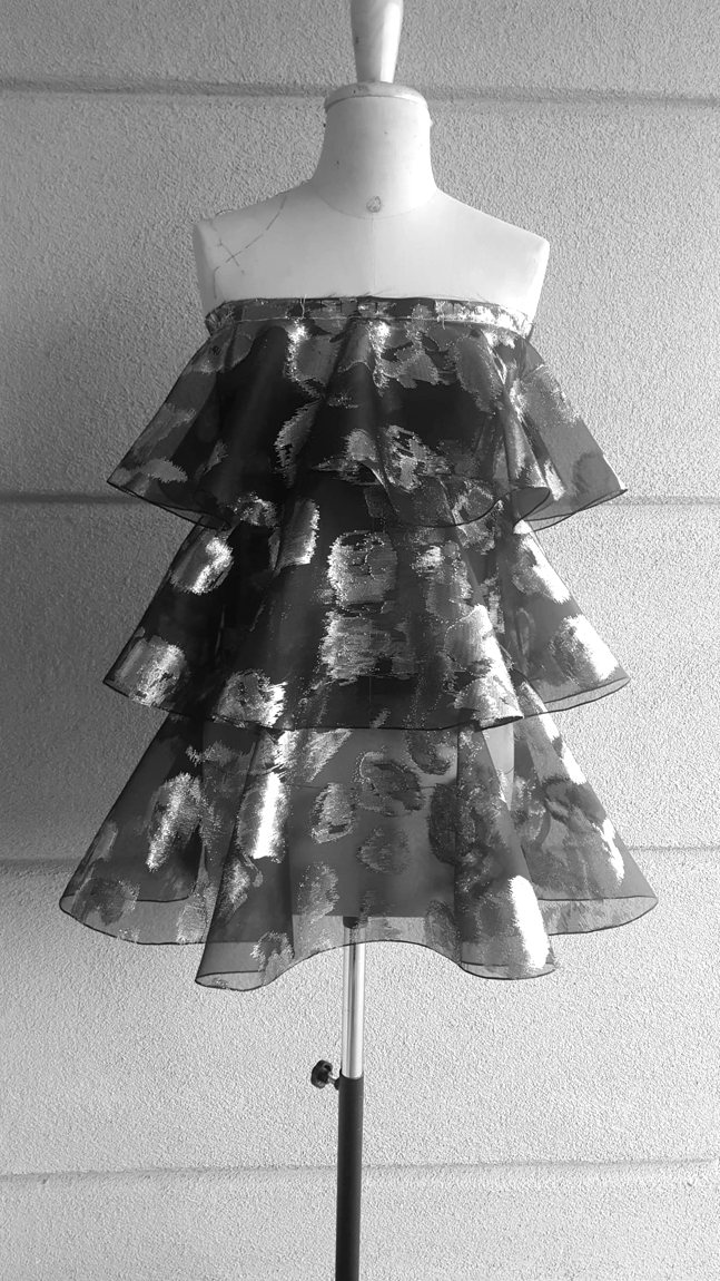 The rose-organza tiered dress on the form, made in Italy in the atelier